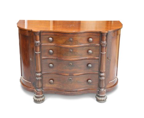 A 19TH CENTURY CONTINENTAL ROSEWOOD COMMODE, the burrwood serpentine top above four conforming graduated drawers, each fitted