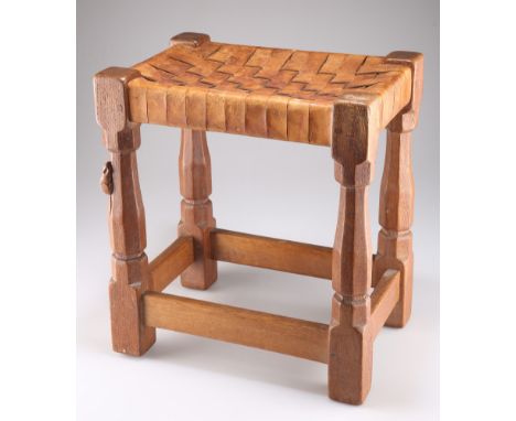 ROBERT THOMPSON OF KILBURN, A MOUSEMAN OAK STOOL, with woven leather strapwork seat, on four octagonal legs, the block feet j