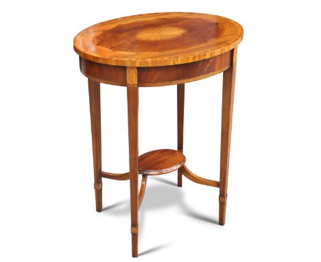 AN EDWARDIAN SATINWOOD AND MAHOGANY OCCASIONAL TABLE, oval, raised on square-section tapering legs joined by a shelf-formed s