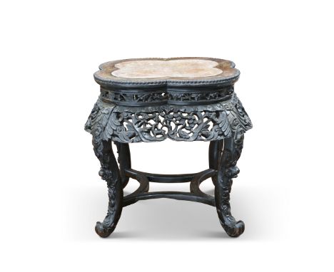A CHINESE MARBLE-INSET HARDWOOD JARDINIÈRE STAND, CIRCA 1900, the lobed top with beaded border, above a pierced and boldly fo