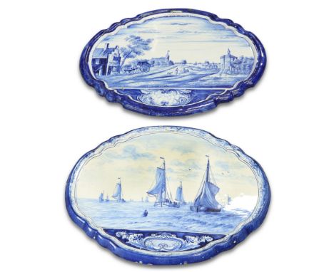 TWO SIMILAR DUTCH DELFT BLUE AND WHITE SHAPED OVAL WALL PLAQUES, PROBABLY MAKKUM, 19TH CENTURY, one painted with a seascape, 