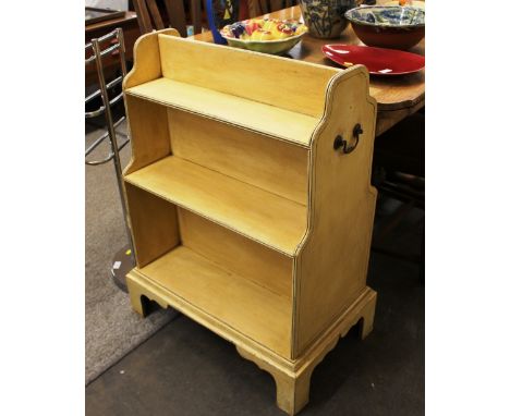 A Georgian design painted donkey bookcase, flanked by brass side carrying handles, raised on bracket supports, 65cm wide x 86