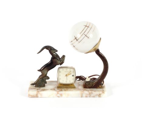 A French Art Deco table lamp clock, with antelope decoration, 27cm long