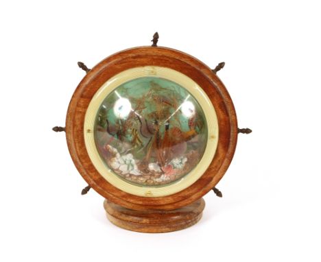 A retro table lamp, in the form of a ship's wheel with fish and shell decoration