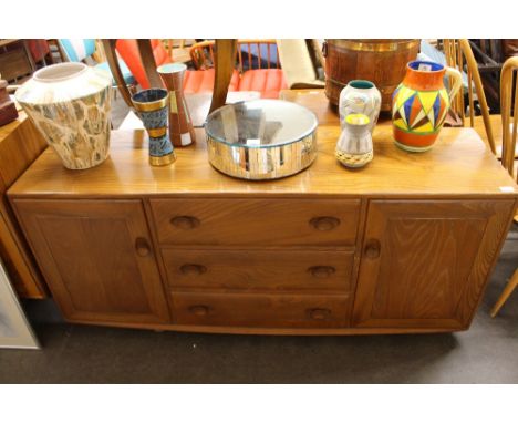 An Ercol sideboard, fitted three central drawers flanked by cupboards, 155cm wide