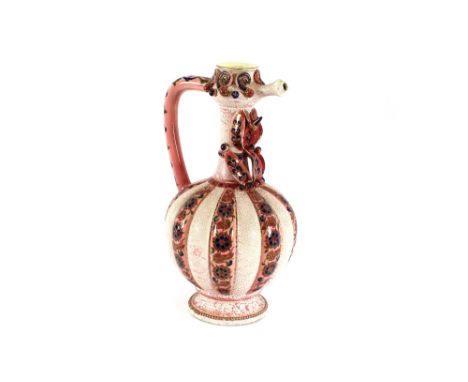 A large Zsolnay pécs jug, of baluster ribbed form, having trailing foliate decoration on a pink ground with raised flowerhead
