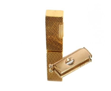 A 9ct gold cigar cutter, with engine turned decoration; and a gold plated Consul cigarette lighter