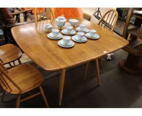 A blonde Ercol drop leaf kitchen table, raised on tapering square section supports, 120cm x 110cm extended