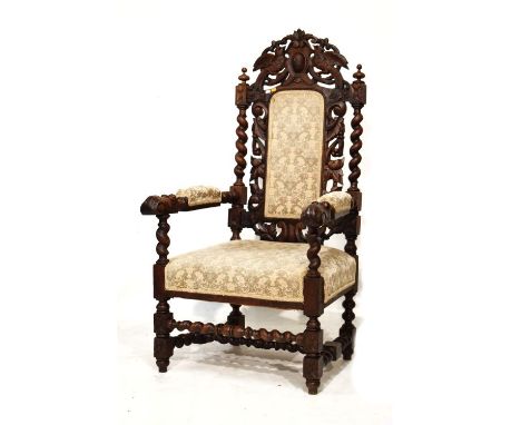 19th Century heavily carved oak high back elbow chair, the seat and back upholstered in simulated tapestry and standing on tu