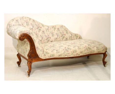 Late Victorian rosewood framed chaise longue upholstered in floral patterned simulated tapestry and standing on cabriole supp