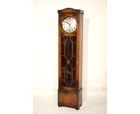 1920's period three weight chiming longcase clock with silvered circular Arabic dial and glazed long trunk door enclosing thr