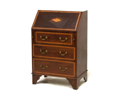 Early 20th Century satinwood crossbanded mahogany bureau, the fall flap opening to reveal a fitted interior, three long drawe