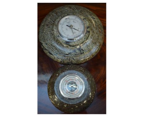 Two serpentine cased aneroid barometers, each of circular form, the larger with silvered scale reading from 28" to 31" of pre