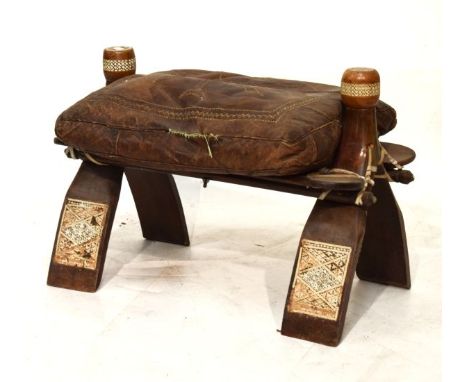 Middle Eastern camel stool with stitched decorated leather cushion on wishbone supports decorated with panels   Condition: 