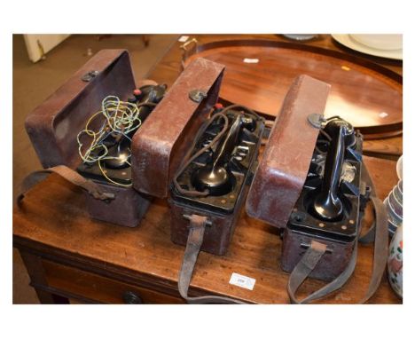 Three cased GPO field telephones, each with Bakelite handset in hinged heavy duty brown plastic case with leather carry strap