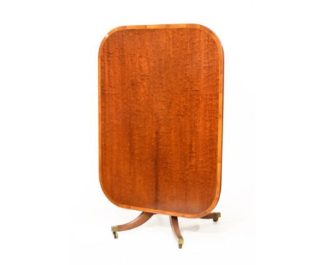 George IV mahogany snap top breakfast table, the top with satinwood banding, standing on a turned pillar and carved and reede