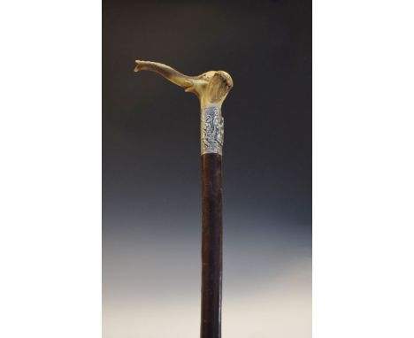 Late 19th/early 20th Century walking stick, the carved antler handle formed as an elephant, the embossed silver collar decora