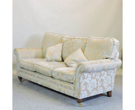 A blue and gold floral upholstered three seater sofa, 204cm