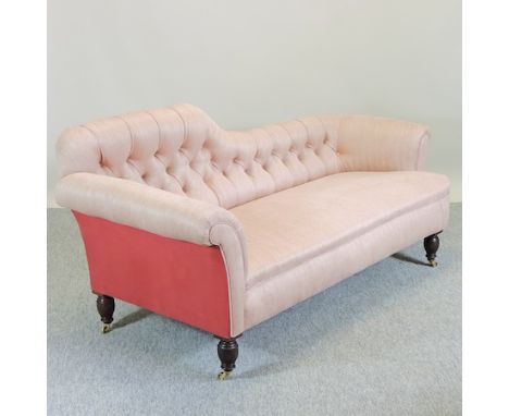 A recently upholstered button back sofa, on turned legs and castors, 182cm 