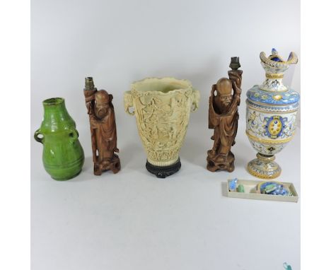 A majolica cantagalli ewer, 41cm tall, together with a Linthorpe style green glazed pottery vase, two carved figural table la