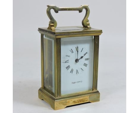 A brass cased carriage clock, by Mappin and Webb, with a white enamel dial, 15cm tall overall