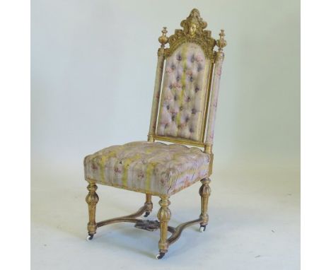 A 19th century upholstered carved and gilt wood side chair, with a button back, on turned legs