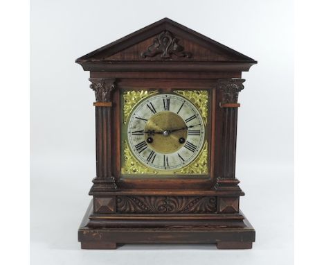 A Victorian walnut cased mantel clock, with a brass dial, 39cm tall