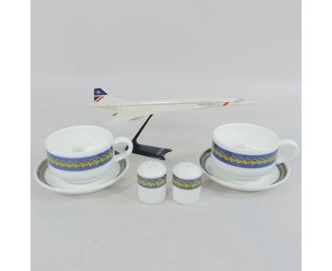 A model of Concord, together with souvenir cups and saucers and a pair of condiments
