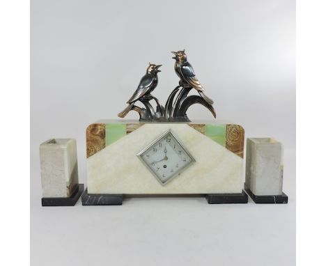 An Art Deco style marble clock garniture, surmounted by birds, 40cm tall