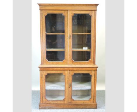 A Victorian light oak glazed bookcase, on a plinth base, 117cm