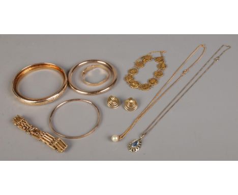 A collection of rolled gold jewellery. To include slave bangles, pendant on chain, gate bracelet and christening bangle etc. 