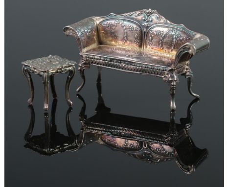 An early 20th century silver continental sofa, along with a similar white metal table. Possibly dolls house furniture. The so