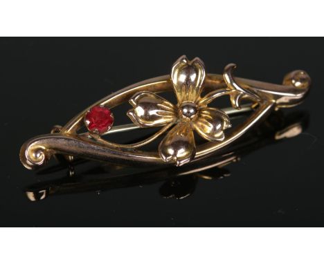 A 9ct gold ruby floral brooch. 1.45g  