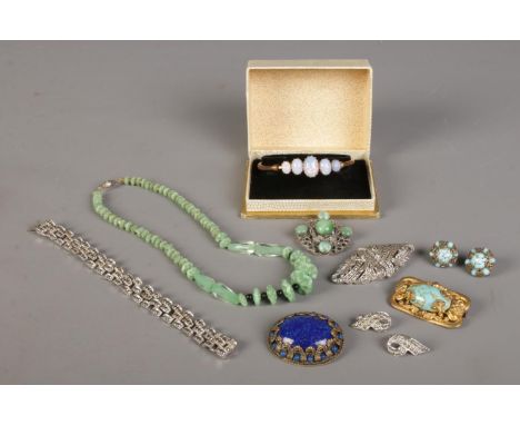 A quantity of costume jewellery, to include boxed bangle marcasite set examples, brooches and necklace etc.  