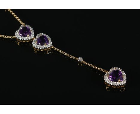 A diamond heart shaped drop-pendant necklace, set with three amethyst coloured stones, on 18ct Gold chain.  