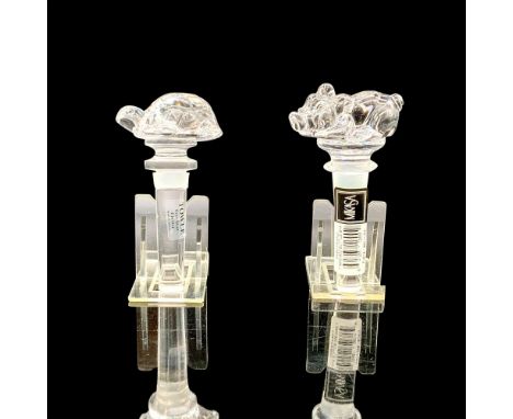 One Mikasa and one Towle clear crystal bottle stopper. The Mikasa bottle stopper depicts a pig at its top and the Towle depic