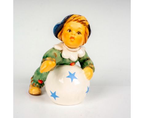 Hand painted porcelain figure. Boy in clown suit rolling around on a ball with stars. Goebel backstamp. M.I. Hummel Club. Exc