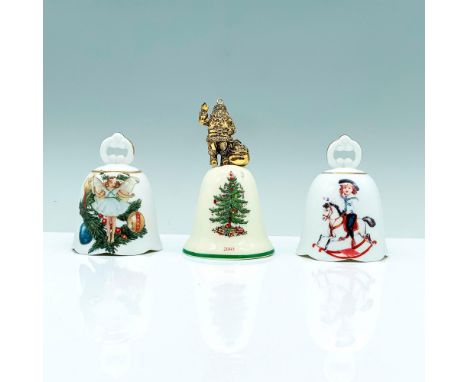 A set of three porcelain bells, one Spode and two WM Reutter. The Spode bell is a cream color and depicts a Christmas tree in