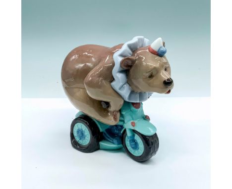 Glossy figurine of a circus bear on a small bicycle. Nao by Lladro backstamp on bottom. Dimensions: 6.5""L x 4""W x 6.25""HMa