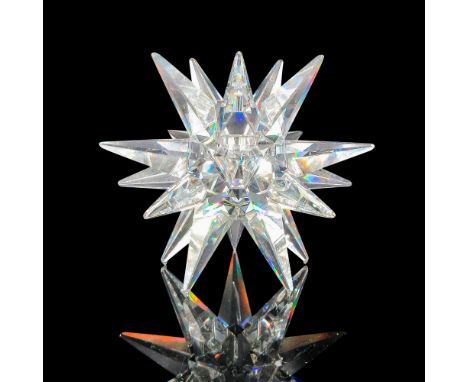 A clear starburst design around candlestick. Swarovski backstamp. This item has its original box: 8.25""H x 6.25""dia. Certif