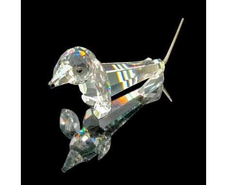 Faceted clear cut crystal with black-colored beaded eyes, nose, and spring-made tail. Swarovski backstamp. This item has its 