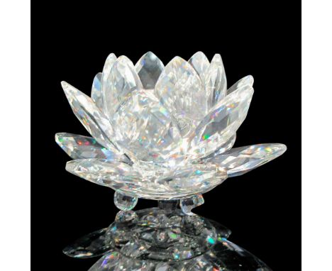Multiple faceted petals surrounds center holder. Round crystal footing on base. Swarovski backstamp. 7600124000. This item ha