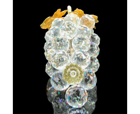 Clear crystal figure on a rhodium stem with gold tone leaves. Swarovski backstamp. 7509150070. This item has its original box