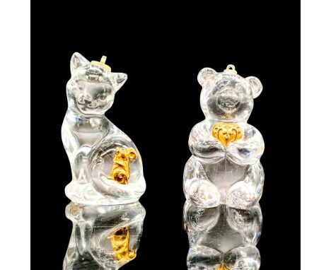 2 ornaments, one is a clear glass bear holding a gold-colored metal heart in his arms and the other is a clear glass cat that