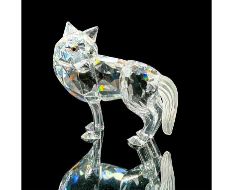 Brilliant clear crystal figure of a wolf standing in an alert pose looking back. Swarovski etched backstamp. This item has it