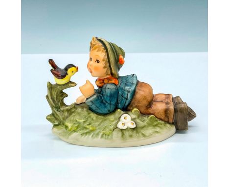 Hummel porcelain figure featuring a boy lying on the ground, tenderly befriending a bird. Goebel backstamp TM8. Issued: 2000-