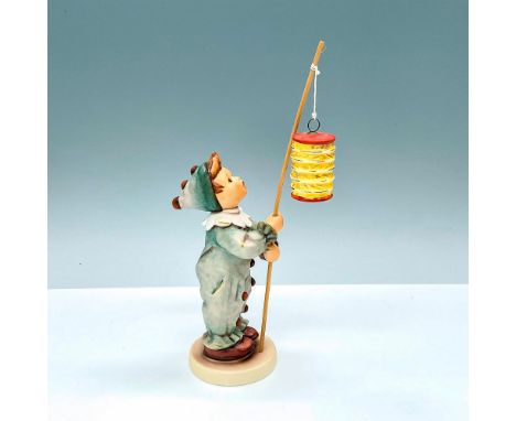 Hummel porcelain figure featuring boy in clown or jester costume holding a lantern. Titled Parade of Lights HUM616. Goebel ba