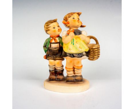 Hand painted porcelain figure. Young Bavarian boy and girl looking up. Girl is holding basket. Goebel backstamp. Artist: M.I.