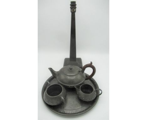 C20th hammered pewter three piece tea service on circular tray and a table lamp, (5) 