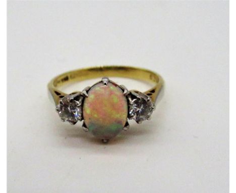 18ct yellow gold opal ring flanked by two diamonds set in a platinum mount, stamped 18ct PLAT, Size K, gross 2.8g 